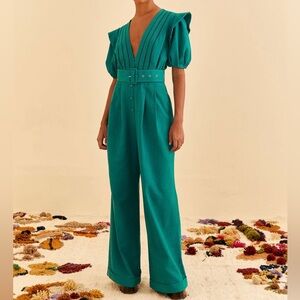 Green jumpsuit, never worn, tags attached. V neckline with puff sleeves, buttons